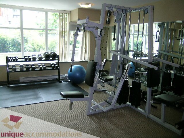 Bright and spacious gym with various exercise equipment and large windows. - 305 - 1030 Quebec Street, Vancouver Downtown
