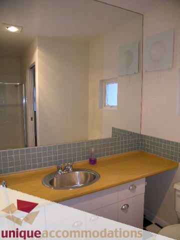 Bathroom with wooden countertop and sink, small window above. - 2234 York Ave, Vancouver West Side