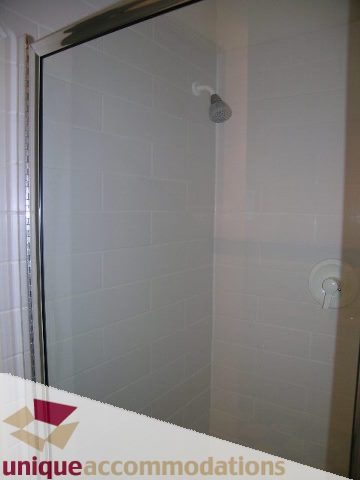 Shower with frosted glass door and modern fixtures. - 2234 York Ave, Vancouver West Side