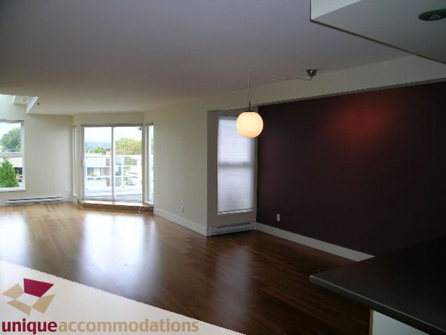 Open kitchen with hardwood floors, city view, and modern lighting. - 2234 York Ave, Vancouver West Side
