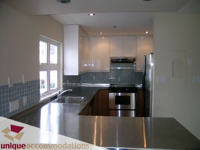 Modern kitchen with stainless steel countertops and sleek cabinetry. - 2234 York Ave, Vancouver West Side