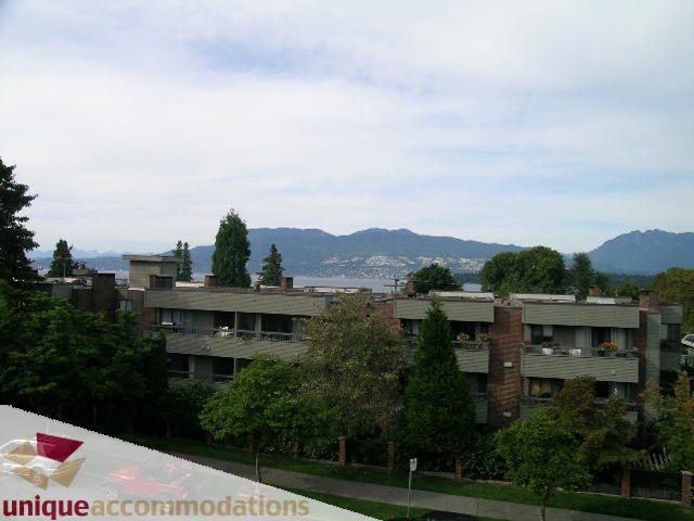 Furnished living room with city view and greenery. - 2234 York Ave, Vancouver West Side