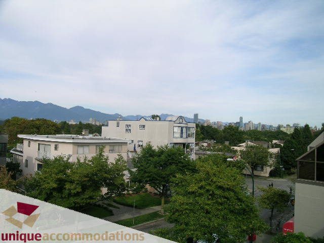 Bright living room with city view and lush greenery. - 2234 York Ave, Vancouver West Side