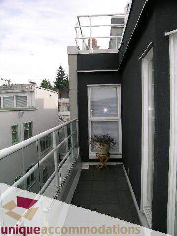 Balcony with glass railings and city view. - 2234 York Ave, Vancouver West Side