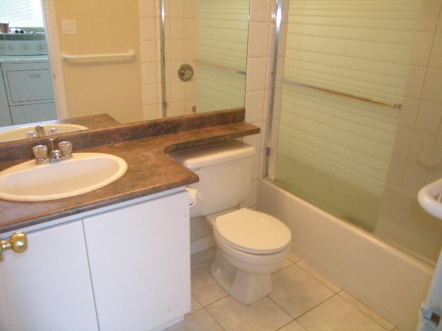 Bathroom with granite countertops and a walk-in shower. - 660 Blueridge Ave, North Vancouver