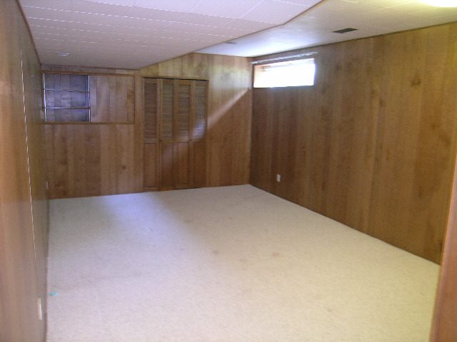 Spacious den with wood-paneled walls and a window, perfect for relaxation. - 660 Blueridge Ave, North Vancouver