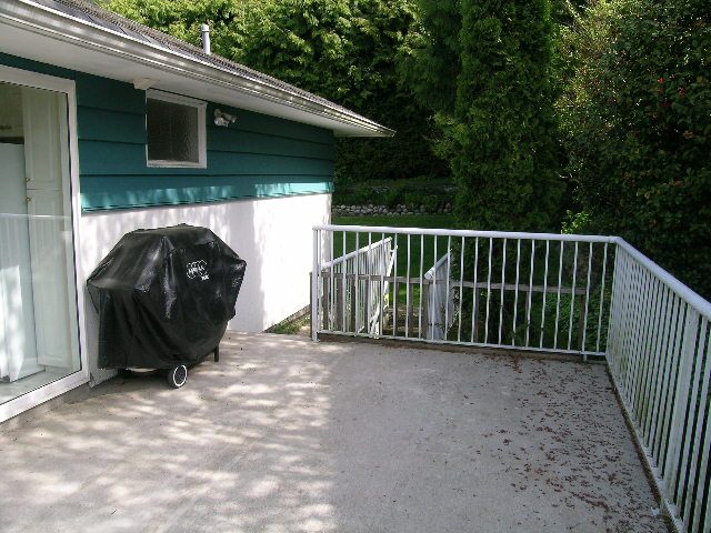 Spacious patio with white railings and a barbecue, perfect for outdoor entertaining. - 660 Blueridge Ave, North Vancouver
