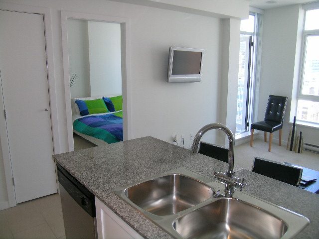 Spacious 1-bedroom condo with granite countertops, modern sink, and city view. - 1703 - 480 Robson Street, Vancouver Downtown