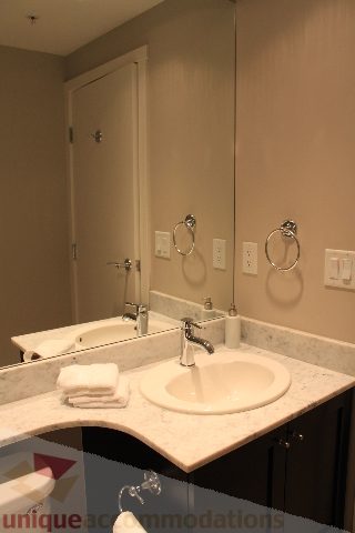 Bathroom with marble countertop and modern sink fixtures. - 2103 - 1001 Homer Street, Vancouver Downtown