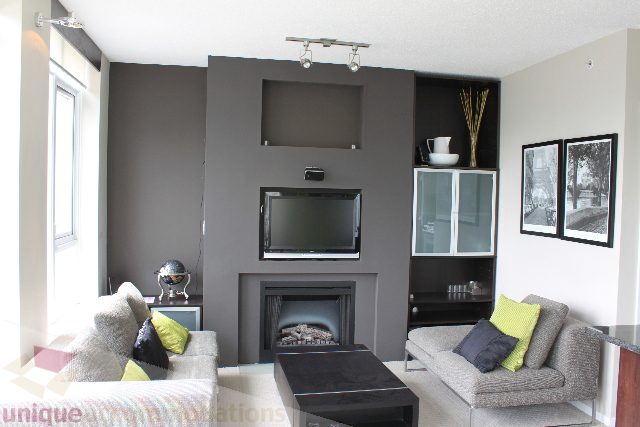 Furnished living room with modern decor, large window, and built-in entertainment unit. - 2103 - 1001 Homer Street, Vancouver Downtown