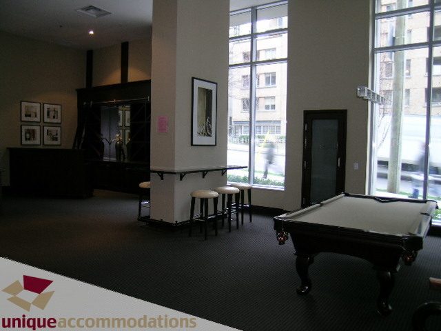 Furnished living room with pool table, large windows, and modern decor. - 2103 - 1001 Homer Street, Vancouver Downtown