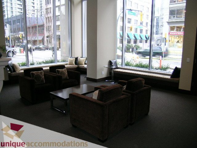 Furnished living room with large windows, city view, and plush seating. - 2103 - 1001 Homer Street, Vancouver Downtown