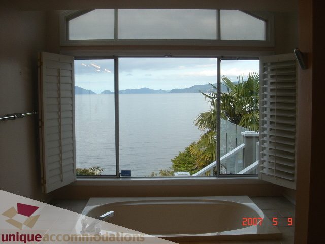 Spacious bathroom with a stunning ocean view and large windows. - 100 Lions Bay Avenue, West Vancouver