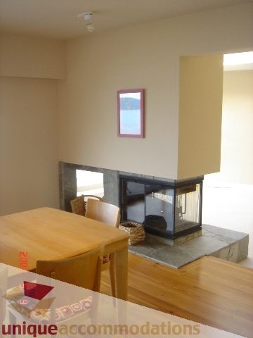 Furnished dining area with hardwood floors and a fireplace. - 100 Lions Bay Avenue, West Vancouver