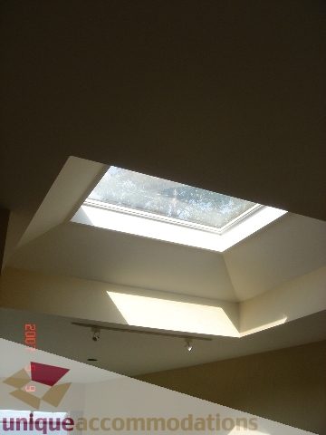 Bright skylit bedroom with modern ceiling design and natural light. - 100 Lions Bay Avenue, West Vancouver