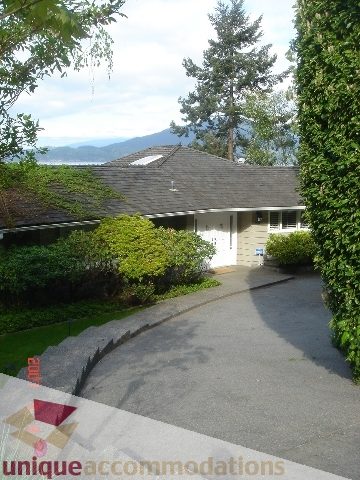 Furnished living room with a view of the mountains and lush greenery. - 100 Lions Bay Avenue, West Vancouver