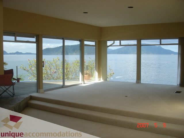 Spacious living room with panoramic ocean view and large windows. - 100 Lions Bay Avenue, West Vancouver
