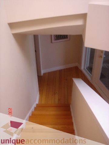 Staircase leading to upper floor with hardwood floors and white walls. - 100 Lions Bay Avenue, West Vancouver