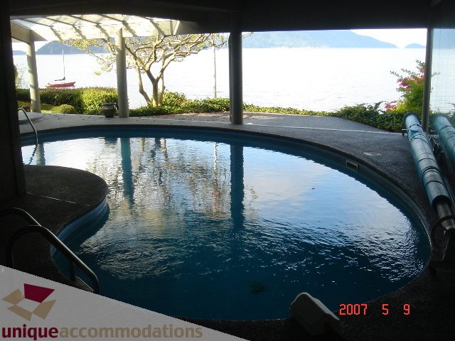 Spacious patio with a serene ocean view and a private hot tub. - 100 Lions Bay Avenue, West Vancouver