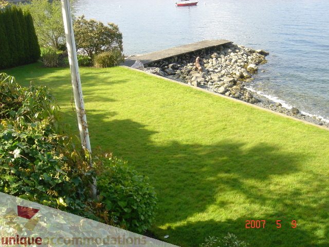 Furnished living room with a view of the water and greenery. - 100 Lions Bay Avenue, West Vancouver