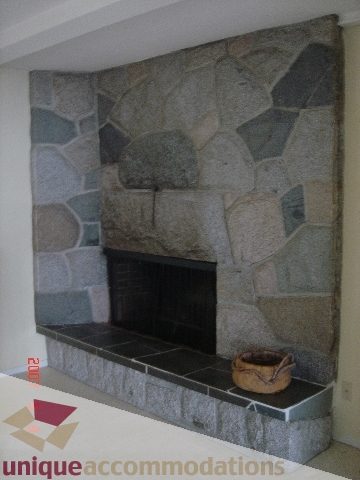Framed stone fireplace with unique mosaic pattern, modern decor. - 100 Lions Bay Avenue, West Vancouver