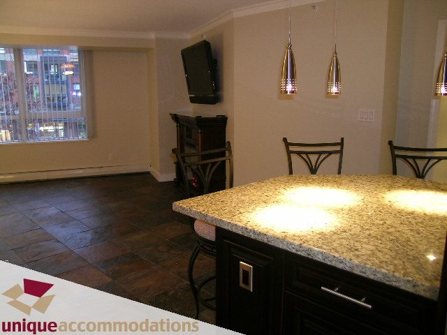Bright kitchen with granite countertops, city view, and modern lighting. - 2C - 199 Drake Street, Vancouver Downtown