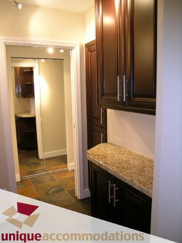 Bright kitchen with dark cabinetry and granite countertops. - 2C - 199 Drake Street, Vancouver Downtown