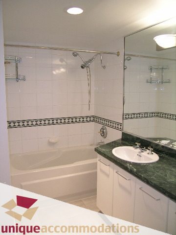 Furnished bathroom with green marble countertops and white cabinetry. - 2C - 199 Drake Street, Vancouver Downtown