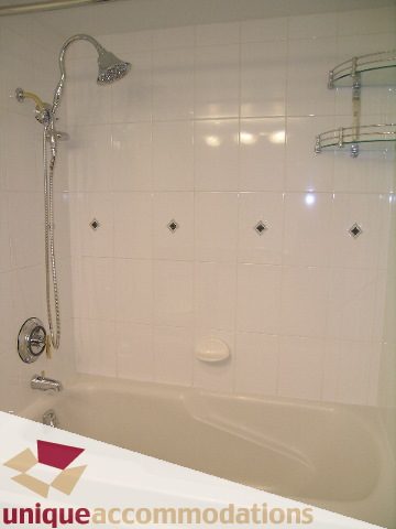 Bathroom with bathtub, tiled walls, and showerhead. - 2C - 199 Drake Street, Vancouver Downtown