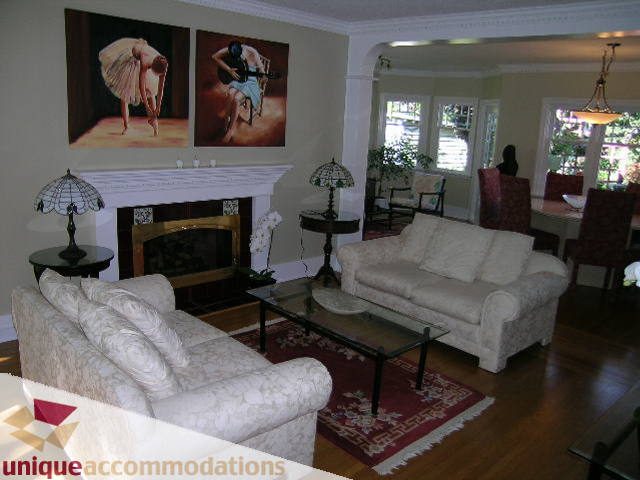 Furnished living room with white furniture, hardwood floors, and large windows. - 4177 West 15th Avenue, Vancouver West Side