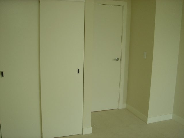 Bright bedroom with sliding closet doors and carpeted floor. - 902 - 1925 Alberni Street, Vancouver Downtown