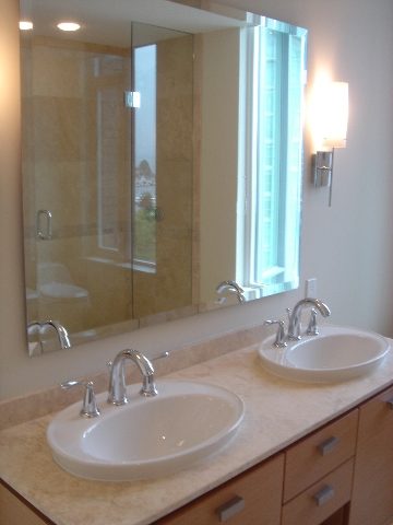 Bright bathroom with large mirror, modern sink, and city view. - 902 - 1925 Alberni Street, Vancouver Downtown