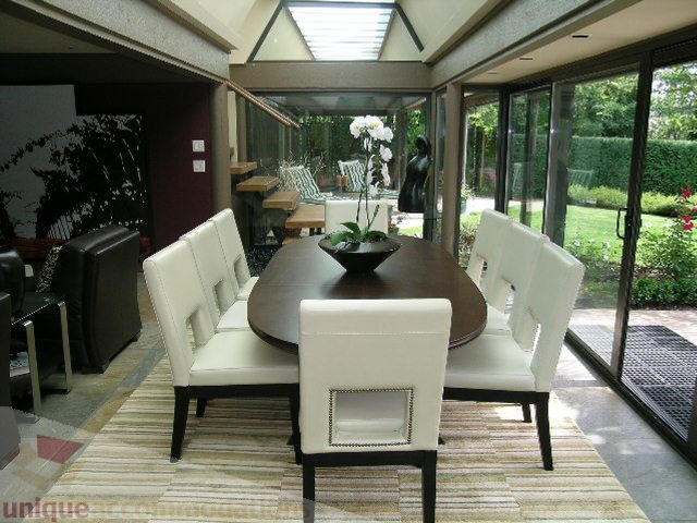 Bright dining room with large windows, modern furniture, and a view of the garden. - 455 Keith Road, West Vancouver