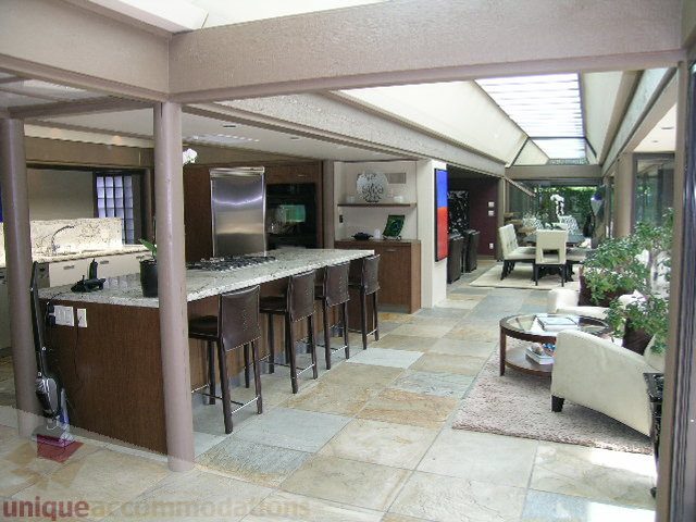 Open-concept living area with granite countertops and large windows. - 455 Keith Road, West Vancouver