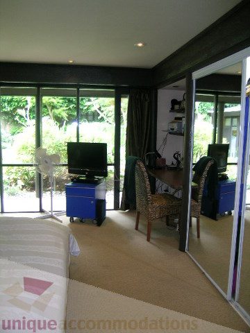 Furnished living room with large windows, hardwood floors, and outdoor view. - 455 Keith Road, West Vancouver