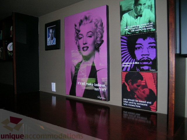 Furnished living room with vibrant wall art featuring Marilyn Monroe and Jimi Hendrix. - 455 Keith Road, West Vancouver