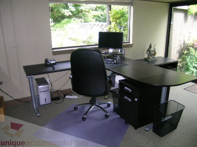 Furnished office space with desk, chair, and window view. - 455 Keith Road, West Vancouver