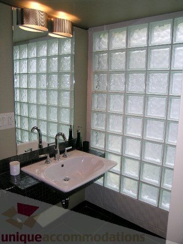 Furnished bathroom with glass block wall and modern sink. - 455 Keith Road, West Vancouver