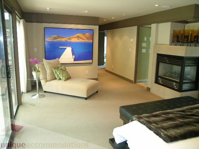 Furnished living room with a large painting, fireplace, and comfortable seating. - 455 Keith Road, West Vancouver
