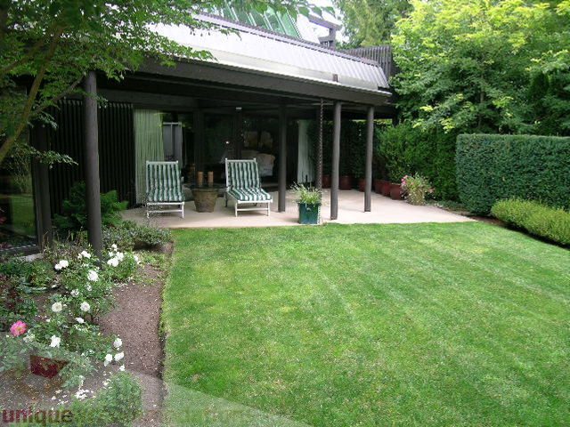 Furnished patio with greenery and outdoor seating. - 455 Keith Road, West Vancouver