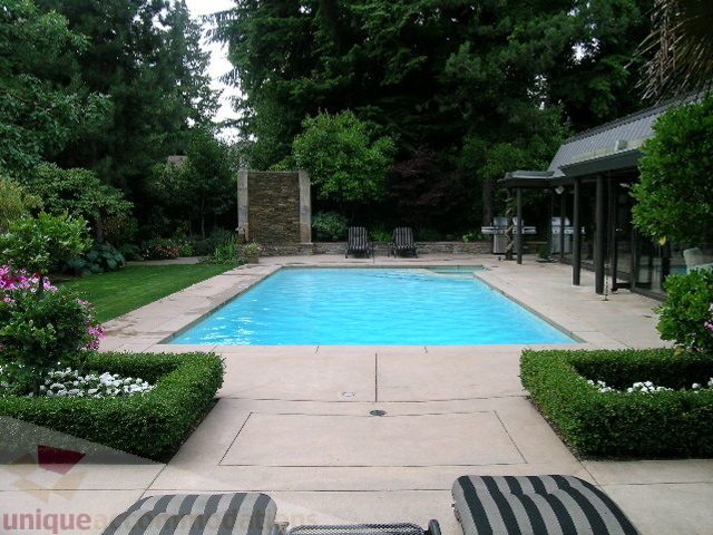 Spacious backyard with pool, patio, and lush greenery. - 455 Keith Road, West Vancouver
