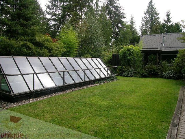 Furnished patio with solar panels and lush greenery. - 455 Keith Road, West Vancouver