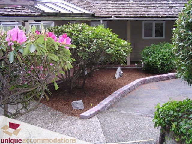 Furnished patio with stone pathway and blooming shrubs. - 3580 Westmount Court, West Vancouver