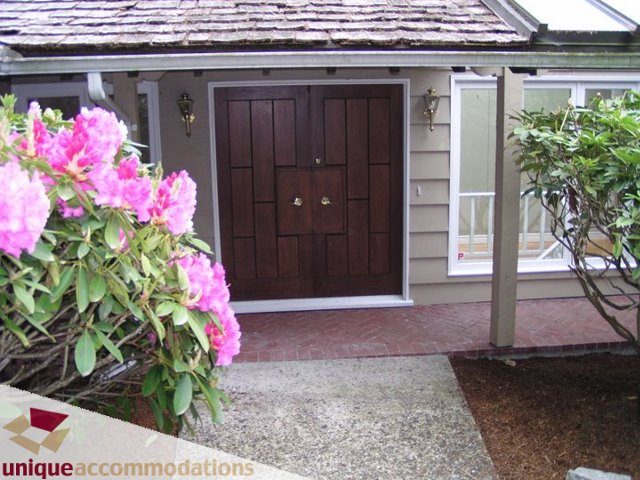 Furnished house with a welcoming front door and blooming flowers. - 3580 Westmount Court, West Vancouver