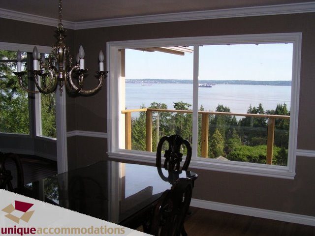 Dining room with chandelier, view of water and trees. - 3580 Westmount Court, West Vancouver