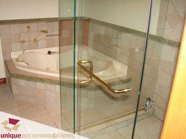 Spacious bathroom with glass shower and corner bathtub. - 3580 Westmount Court, West Vancouver