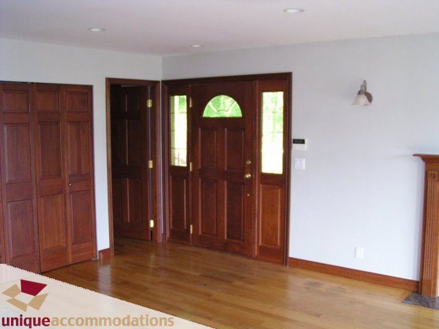 Bright entryway with hardwood floors and wooden paneling. - 3580 Westmount Court, West Vancouver