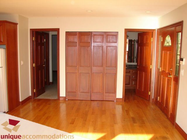 Bright entryway with wooden doors and hardwood floors. - 3580 Westmount Court, West Vancouver