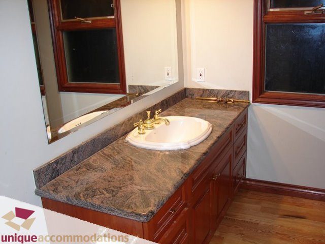 Bathroom with granite countertop and wooden cabinets. - 3580 Westmount Court, West Vancouver