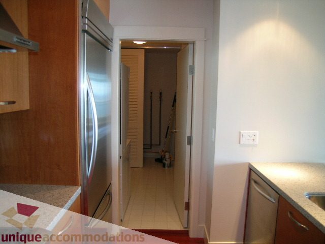 Bright kitchen with granite countertops and stainless steel appliances. - 1302 - 3355 Cypress Pl, West Vancouver